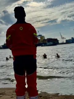 Rettungsschwimmer passt auf Menschen im Wasser auf